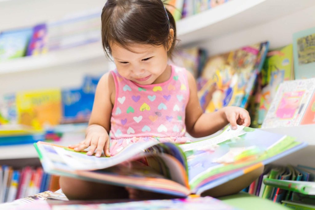 Little girl reading a book