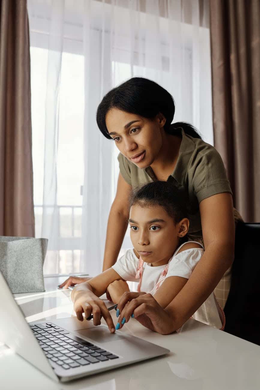 mother helping her daughter with homework