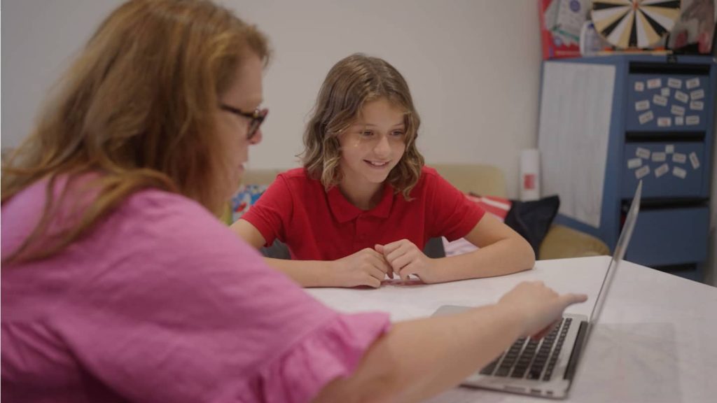 Educator doing an online dyslexia test with a student.